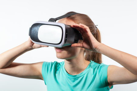 Girl in virtual reality glasses watching surprised shocking video. Young woman looking at futuristic social network map conceptの写真素材