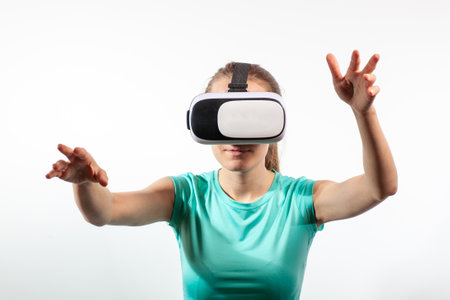 Girl in virtual reality glasses watching surprised shocking video. Young woman looking at futuristic social network map conceptの写真素材