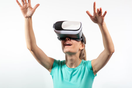 Girl in virtual reality glasses watching surprised shocking video. Young woman looking at futuristic social network map conceptの写真素材
