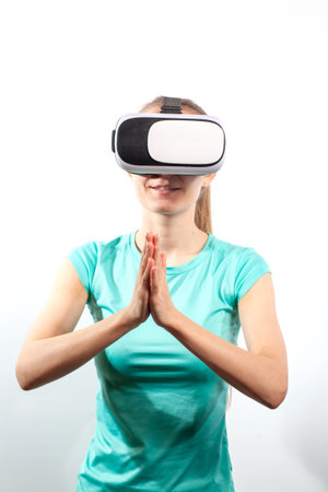 Girl in virtual reality glasses watching surprised shocking video. Young woman looking at futuristic social network map conceptの写真素材