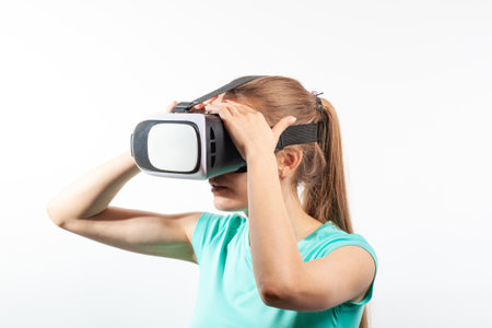 Girl in virtual reality glasses watching surprised shocking video. Young woman looking at futuristic social network map conceptの写真素材