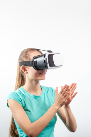 Girl in virtual reality glasses watching surprised shocking video. Young woman looking at futuristic social network map conceptの写真素材