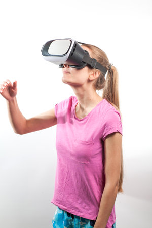 Girl in virtual reality glasses watching surprised shocking video. Young woman looking at futuristic social network map conceptの写真素材