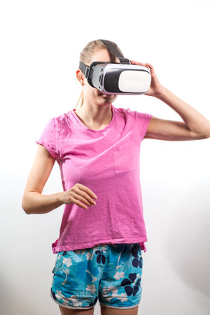 Girl in virtual reality glasses watching surprised shocking video. Young woman looking at futuristic social network map conceptの写真素材
