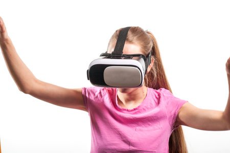 Girl in virtual reality glasses watching surprised shocking video. Young woman looking at futuristic social network map conceptの写真素材