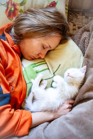 Portrait of a domestic cat of white color with big eyes. Cute clean cat. White cat with a pink nose. White Russian breed of cats.の写真素材