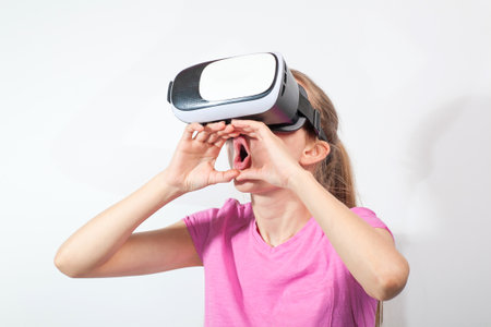 Girl in virtual reality glasses watching surprised shocking video. Young woman looking at futuristic social network map conceptの写真素材