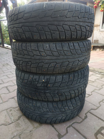 Old worn car tires. Damaged rubber. Old tyres. Recycling of rubber.の写真素材