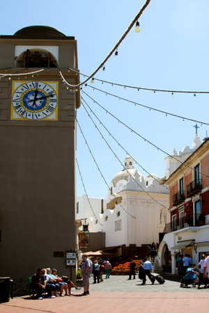 Tower with clock and bell beside square  Piazzetta Ceasare Battisti , Capri, Italy    のeditorial素材