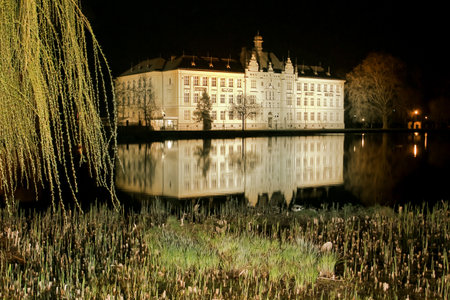 The historic high school building built in 1901 in Litovel by night, in the mirror of pond, Czech Republic のeditorial素材