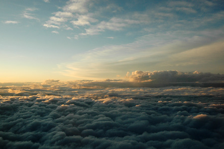 Sky and clouds from flying airplane at dawnの写真素材