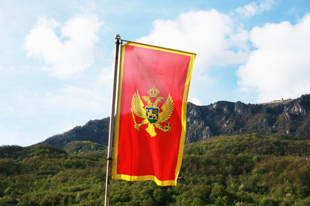 Montenegro flag in a front of mountainsの写真素材