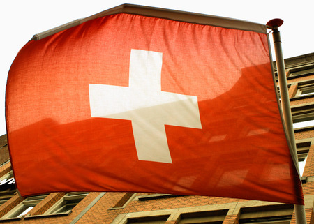 Waving Swiss flag on the windの写真素材