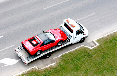 fast oldtimer car on the carrier vehicleの写真素材