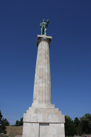 Monument sculpture of the Belgrade Victor made of bronze, located in Kalemegdan park facing the Sava River and Zemun district, Belgrade, Serbia.の写真素材
