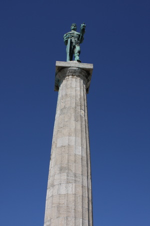Monument sculpture of the Belgrade Victor made of bronze, located in Kalemegdan park facing the Sava River and Zemun district, Belgrade, Serbia.の写真素材