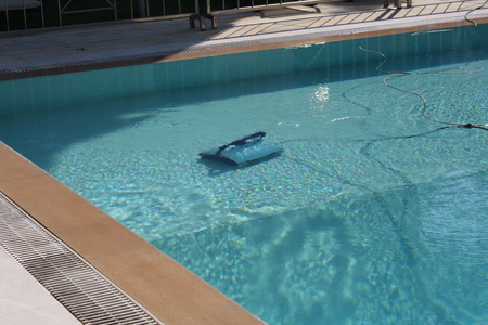 Robot working and cleaning inside swimming poolの写真素材