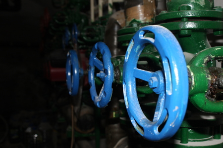 Close up of manual operate blue metal ball valve and pipes industrial equipmentの写真素材