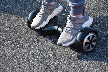 young man riding on the Hoverboard in the parkの写真素材