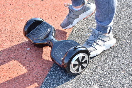 young man riding on the Hoverboard in the parkの写真素材