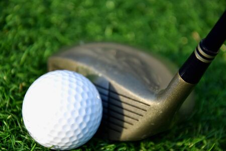 Stick with a ball on an artificial golf courseの写真素材