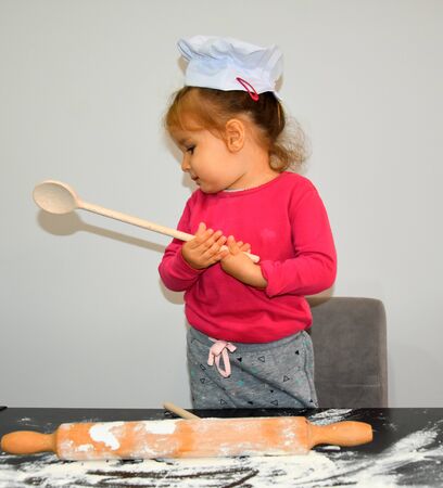 Cute boy cooking in kitchen at homeの写真素材