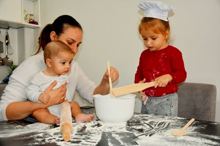 Baker family, Mum with two kids in the kitchenの写真素材