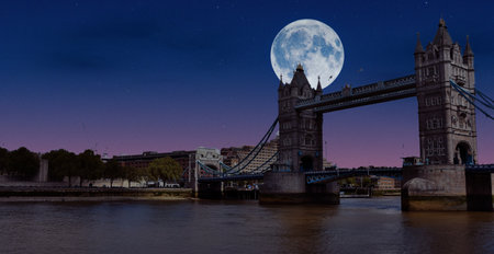 Tower Bridge at night with full moon in London, United Kingdomの写真素材