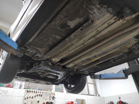 lifted used car wait for repairing in a vehicle repair shopの写真素材