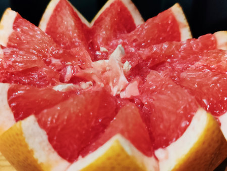 Grapefruit cut in half on a wooden board, closeupの写真素材