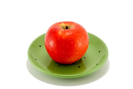 red apple shot in a green  bowlの写真素材