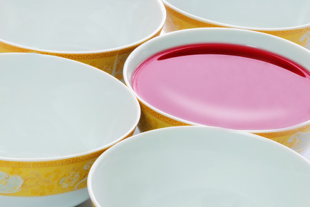 five plates in a row with red liquidの写真素材