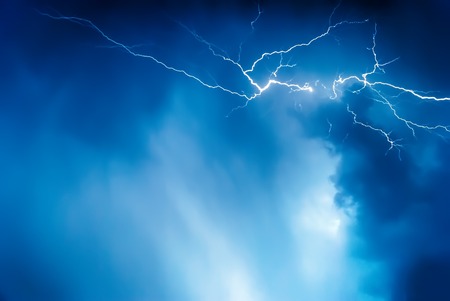 Lightning on the sky is covered with gray clouds in rainy seasonの写真素材