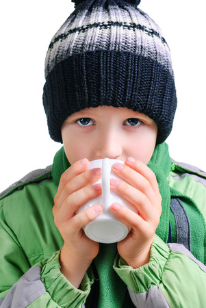 the boy in the winter with a mug of tea in his handsの写真素材