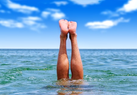 active holiday by the sea. Diving into water