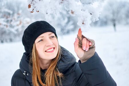 Beautiful Girl playing with snow in parkの写真素材