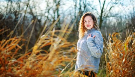 Girl in curls mint on a blurry background in autumnの写真素材