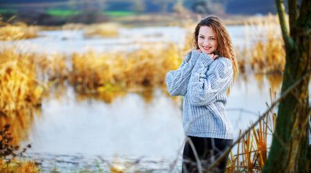 Girl in curls mint on a blurry background in autumnの写真素材