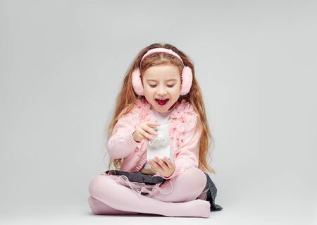 Girl in pink posing in front of the camera close-upの写真素材