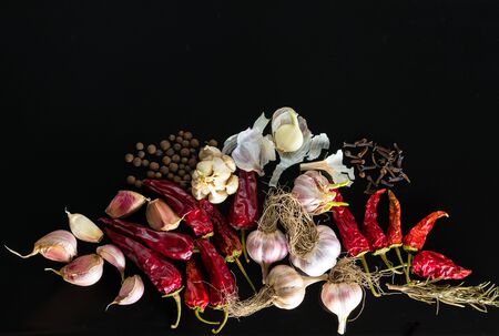 Red hot chili peppers with spice ingredients over black backgroundの写真素材
