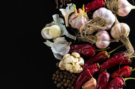 Red hot chili peppers with spice ingredients over black backgroundの写真素材
