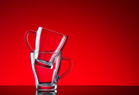 Glass glasses shot in the studio on a red backgroundの写真素材