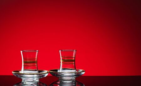 Glass glasses shot in the studio on a red background