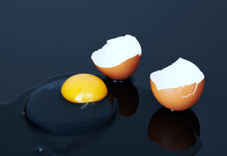 broken chicken eggs on a black background close up