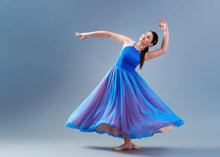 girl beautiful dress is engaged in dancing in the studioの写真素材