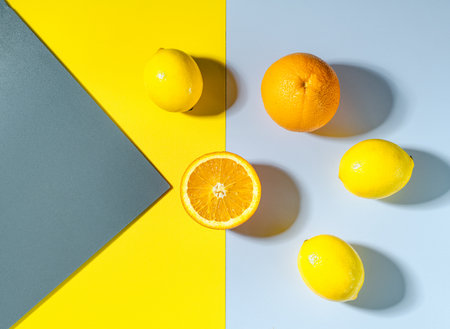 orange on yellow background. Citrus fruit on colored backdrop. Top viewの写真素材