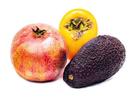 composition of three fruits avocado, pomegranate, persimmon isolated on white background