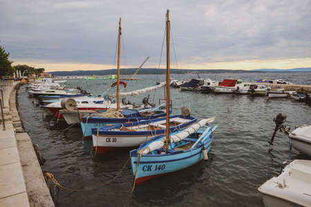 Novi Vinodolski, Croatia-June 24th, 2020: Beautiful, anchored boats, traditional to Dalmatian region of Croatia, anchored at the small port at sunsetのeditorial素材