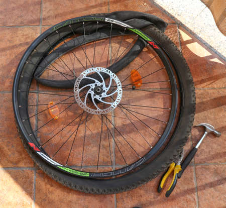 Zagreb, Croatia-March 06th, 2020: Fixing the front bicycle flat tire that got punctured while driving on rough terrainのeditorial素材