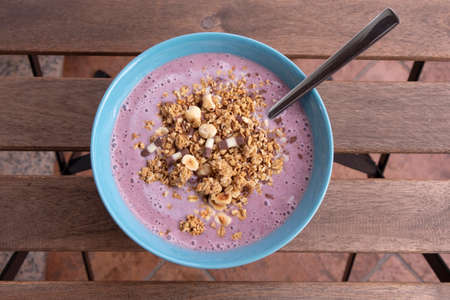 Healthy breakfast, home made strawberry, blueberry, banana and yoghurt smoothie with crunchy muesli and oat flakesの写真素材
